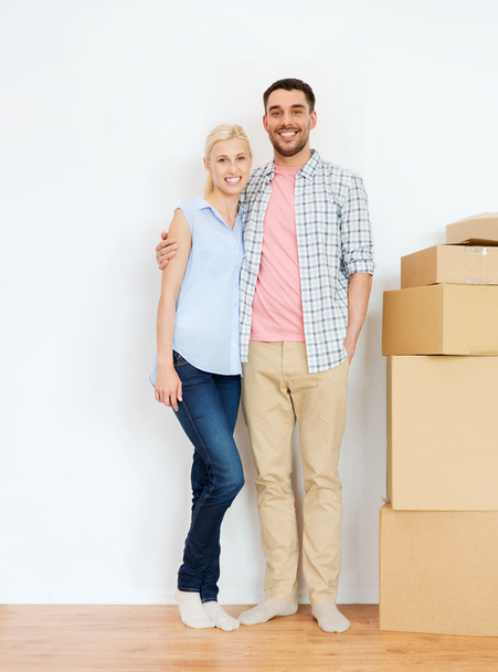 couple with cardboard boxes moving to new home - 写真・画像