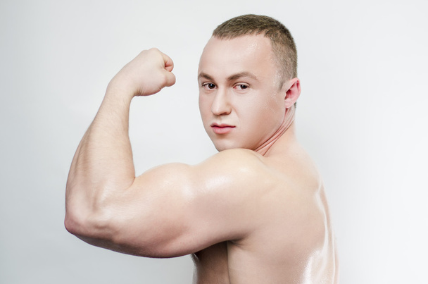 pumped male bodybuilder showing muscles - Foto, Imagen