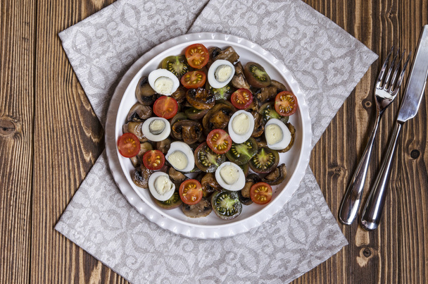 Salad with cherry tomatoes mushrooms and quail eggs with blue cheese dressing - Fotoğraf, Görsel