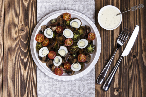 Salad with cherry tomatoes mushrooms and quail eggs with blue cheese dressing - Photo, Image
