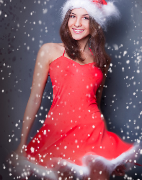 Portrait of beautiful young christmas woman posing wearing santa - Photo, Image