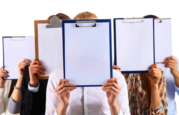 Team of businesspeople holding a folders near face isolated on white background - Фото, зображення