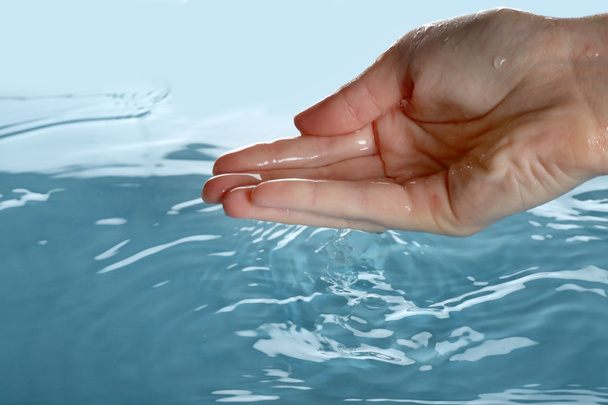 Finger touches water  - Фото, зображення