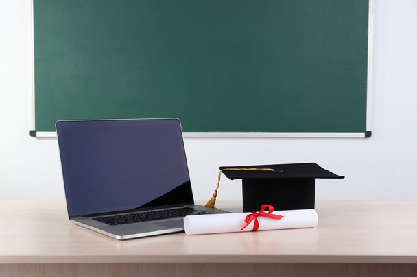 Notebook with diploma and master hat - Φωτογραφία, εικόνα