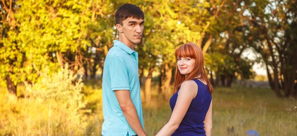 young couple walking hand in the forest outdoors - Foto, Bild