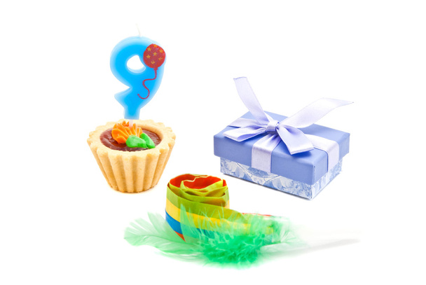cake with nine years birthday candle, whistle and gift on white - Фото, зображення