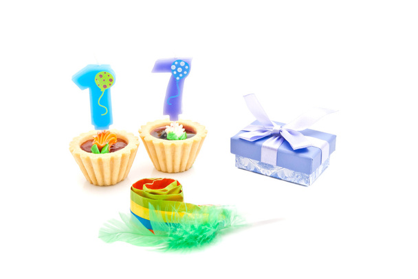 cakes with seventeen years birthday candles, whistle and gift on - Φωτογραφία, εικόνα