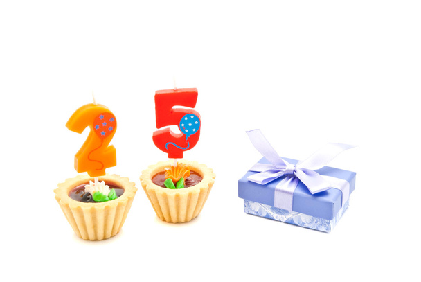 cakes with twenty five years birthday candles and gift on white - Фото, зображення