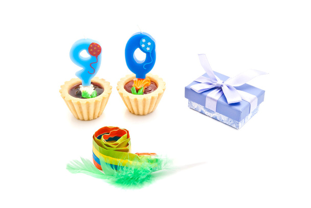 cakes with ninety years birthday candles, whistle and gift on wh - Φωτογραφία, εικόνα