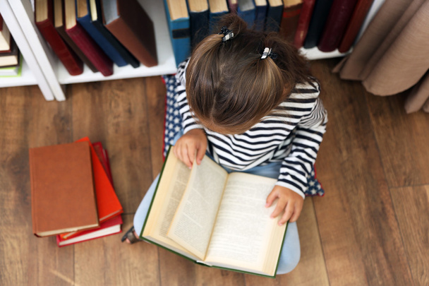 Beautiful little girl with books - Фото, изображение