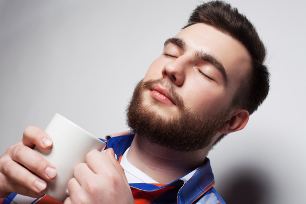 young bearded man with a cup of coffee - Foto, Imagem