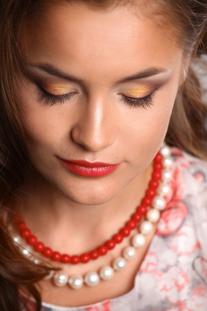 Portrait of young beautiful brunette woman in beads  - Foto, Imagem