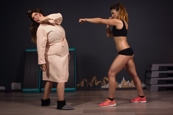 Athletic girl struggling with fat women - Photo, Image