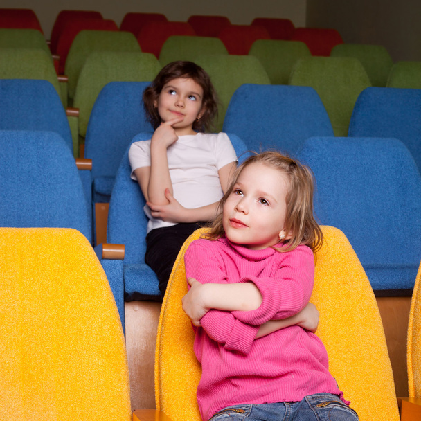 little girls sitting in cinema hall - Zdjęcie, obraz