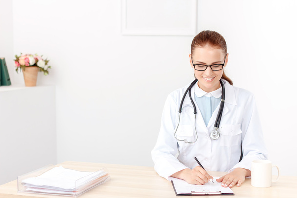 Professional doctor sitting at the table  - Foto, Imagen