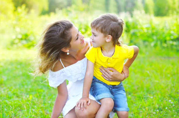 Happy mother with child son together outdoors in summer day - Fotoğraf, Görsel