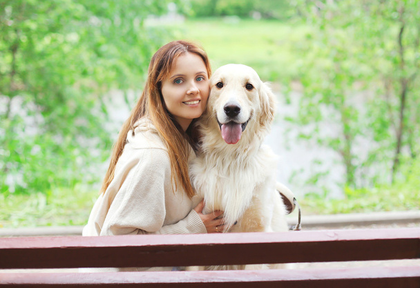 Portrait of happy owner woman and Golden Retriever dog sitting t - Photo, Image