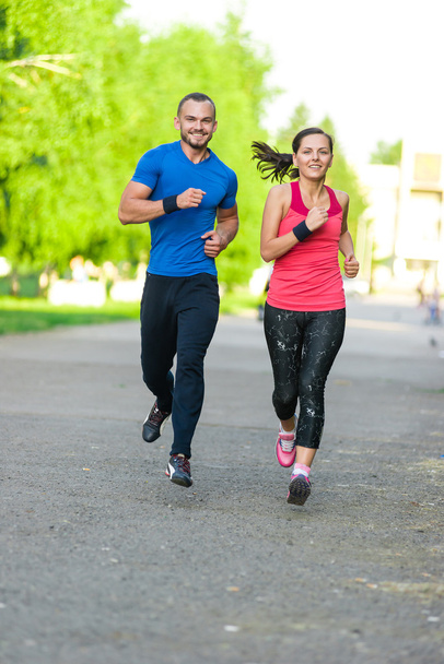 Runners training outdoors working out. City running couple jogging outside.  - Foto, Bild