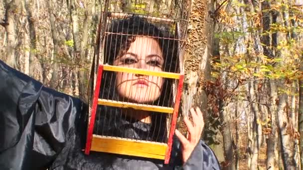 Woman In Black With Cage On Her Head In Autumn Forest - Footage, Video