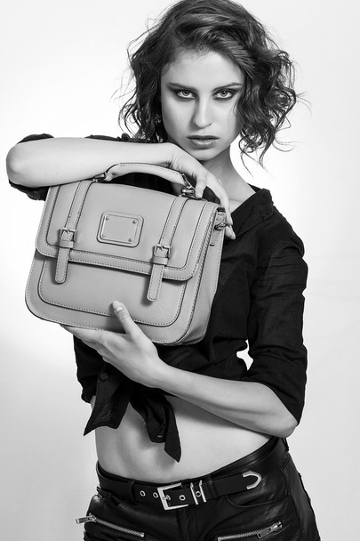 Beautiful girl holding a bag and looking black and white - Photo, image