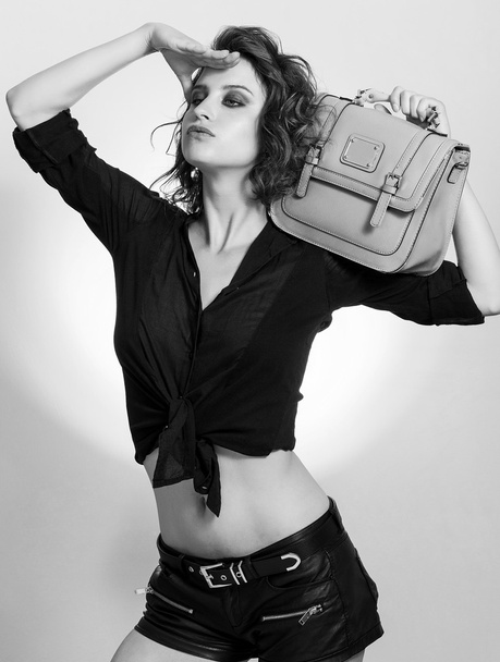 Girl holding bag and looking far away black and white - Valokuva, kuva