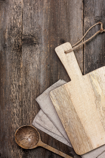 Cutting board on old wooden background - Foto, afbeelding