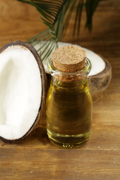 coconut oil in a glass bottle and fresh nuts - Photo, Image