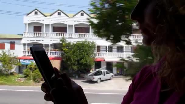 Woman Using Smart Phone on the Road in a Bus - Materiał filmowy, wideo