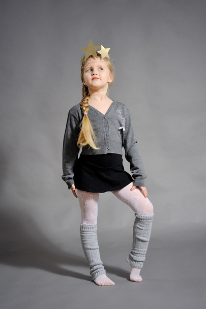Little girl dressed in the New Year on a gray background - Foto, Imagem