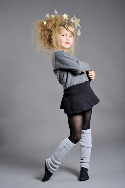 Little girl dressed in the New Year on a gray background. - Foto, Imagem