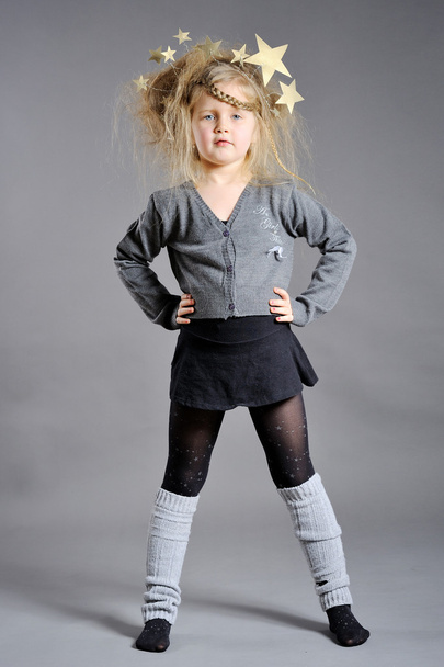 Little girl dressed in the New Year on a gray background - Foto, imagen