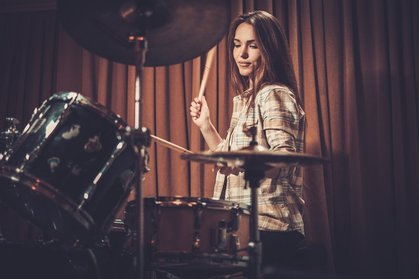 Young cheerful girl behind drums - Foto, Imagen