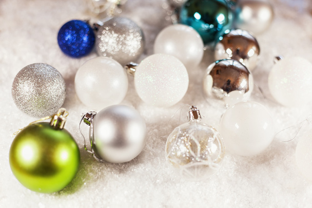 A Lot Of Baubles On Snowy Background - Foto, Imagen