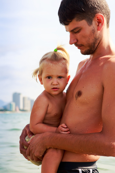 father presses to breast little daughter in sea water closeup - Fotografie, Obrázek