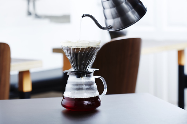 Hot water into coffee maker - Фото, изображение