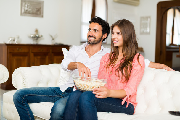 smiling couple watching tv - Photo, Image