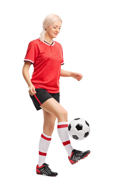Female soccer player juggling a ball - 写真・画像