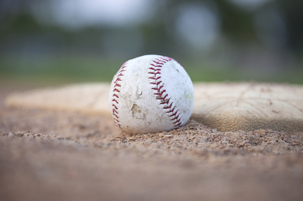 Selective focus low angle of grungy baseball and base - Photo, Image