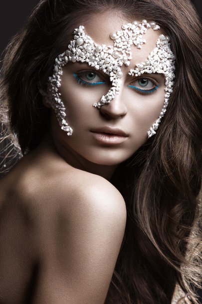 Beautiful dark-haired girl with a fashionable creative makeup. Beauty face. Art image.  - Foto, Imagen