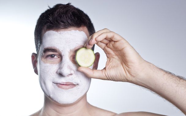 handsome man with clay facial mask in beauty spa - Photo, Image