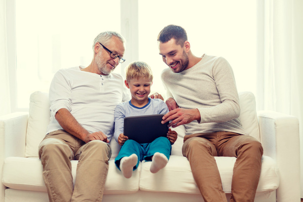smiling family with tablet pc at home - Photo, Image