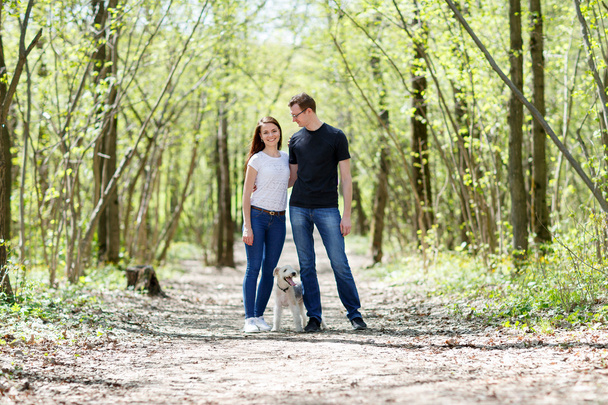 Happy young couple and  dog - Photo, image