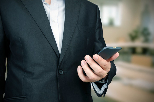 Business man using smart phone in office - Fotó, kép