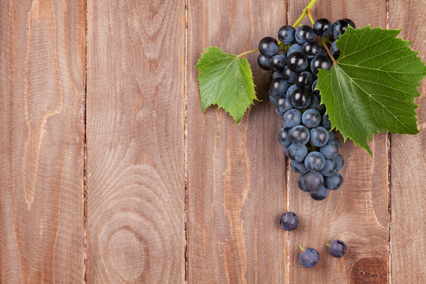 Red grape on wooden table - Photo, image