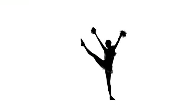 Young cheerleader with pom-poms smiling at camera, acrobatic wheel double, Silhoutte - Video, Çekim