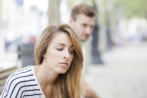 Portrait of young woman and man outdoor on street having relationship problems - Foto, Imagem