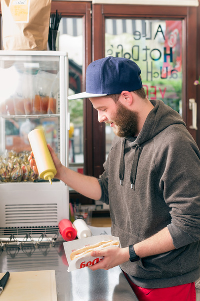 vendedor haciendo hotdog en snack bar de comida rápida
 - Foto, imagen