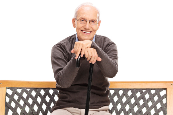senior gentleman with a cane sitting on a bench - Photo, Image