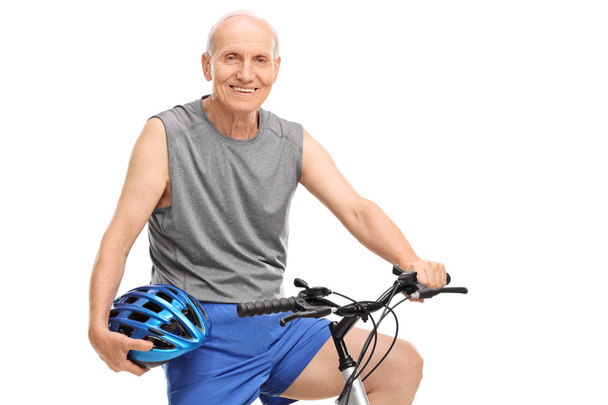 Senior biker holding a blue helmet - Foto, immagini
