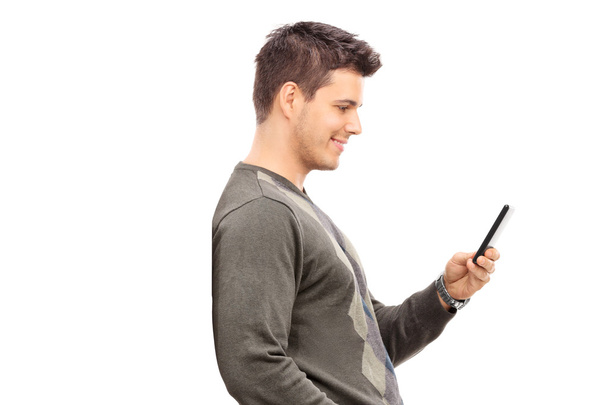 Young man texting on cell phone - Fotó, kép
